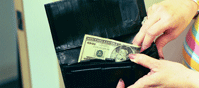 a woman putting a twenty dollar bill into a separate section in her wallet