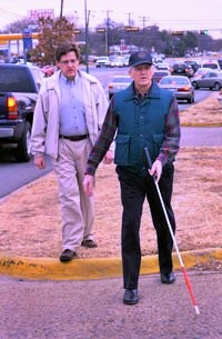 Orientation and Mobility instructor with older man walking with cane