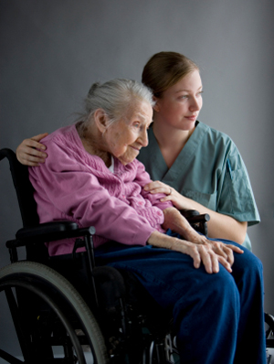Older woman in wheelchair with caregiver