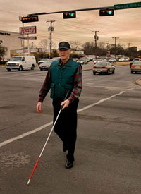 Older man walking with Mobility Cane