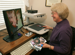 Woman using CCTV to look at photo of children