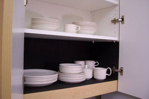 upper picture: white plates on white shelf in cabinet lower picture: white plates on dark shelf paper in cabinet