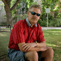 A man sitting on a bench in a park