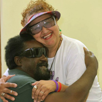 two people with low vision hugging