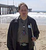 A head shot of Darrell with the Pacific Ocean in the background