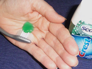 Dispense toothpaste in palm and then scoop it out