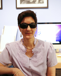 woman at work, her computer screen visible behind her