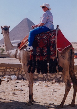 Kaye in 2000 riding a camel at the pyramids in Egypt