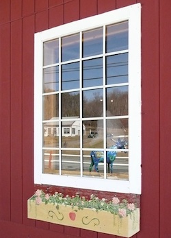 A photo of a window reflecting a blue moose.