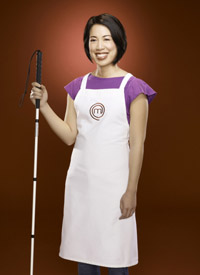 Christine Ha, MasterChef contest, wearing an apron and holding her white cane