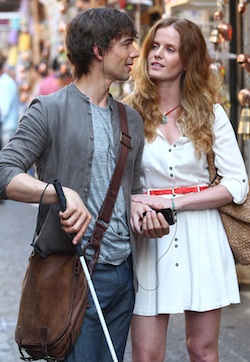 Photo of Christopher Gorham using a white cane in a crowded street in Istanbul