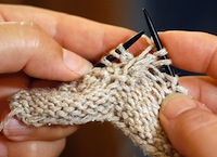 fingers close to the tips of the needles