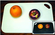 photo of a white cutting board surface and a black cutting board surface to demonstrate contrast