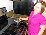 woman who is blind safely using a flat-topped stove