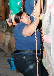 Empish Thomas climbing a rock wall