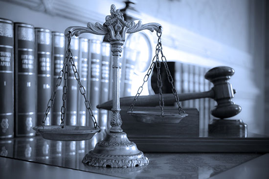 Scales and a gavel on a table as symbols of law and justice.