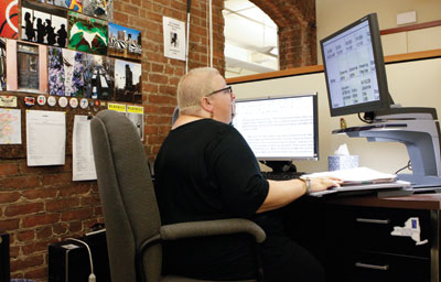 A woman looking at a computer monitor