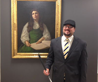 Joe Strechay in the AFB New York office in front of a portrait of Helen Keller