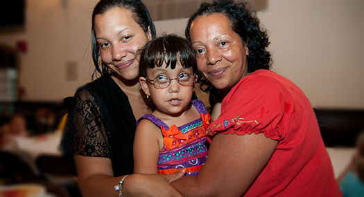 a mom, daughter, and granddaughter hugging