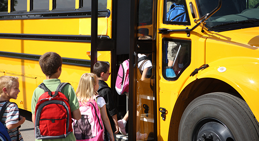 children getting on a yellow schoolbus