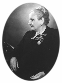 Tilly Aston in later years sitting wearing King's medal; Image courtesy of Vision Australia