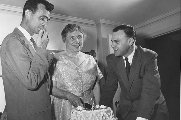 Helen Keller cutting a birthday cake