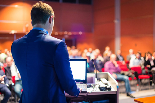 stock photo of man presenting at a conference