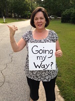 Audrey holding sign saying 'going my way.'