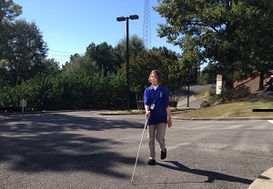 Sue Martin crossing street with cane