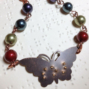 necklace with beads and butterfly with braille