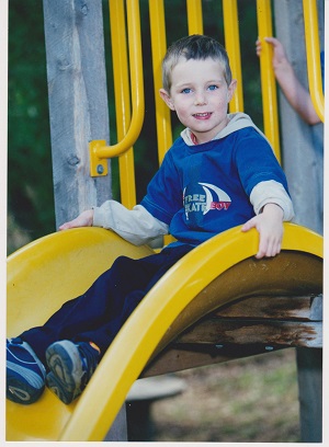 boy sitting on slide