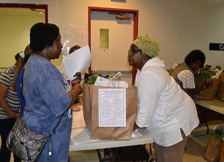 senior receiving bag of food