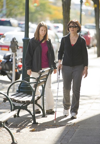 client with cane and instructor