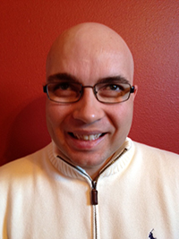 Head shot of Russell Shaffer, smiling and wearing glasses