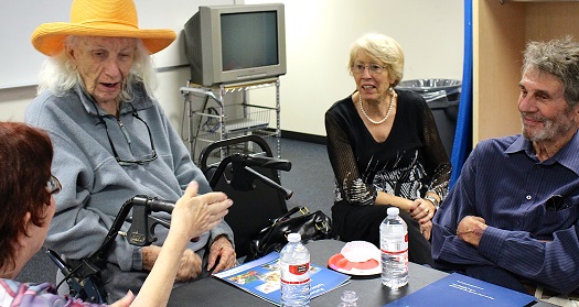 four individuals talking around table