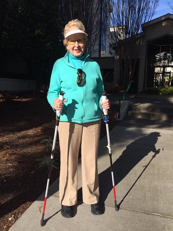 ski poles modified with red and white tape to be used as mobility canes