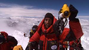 Erik W. ascending a mountain top with a group of climbers