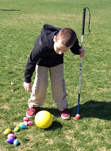 Eddie bending over to pick up eggs