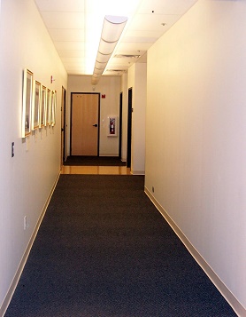 corridor in building with doors at end
