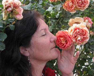 Maribel smelling pink roses