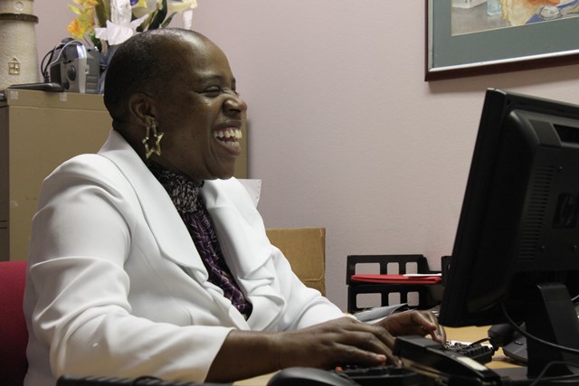 Sharon McDonald smiling at a computer