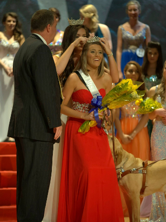 Carly Becknell being crowned at a pageant with Brinkley