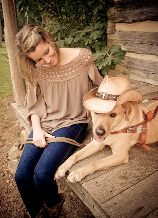 Carly Becknell sitting with guide dog Brinkley 