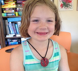 Child wearing a home-made necklace