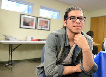 Young blind man sitting and smiling at camera