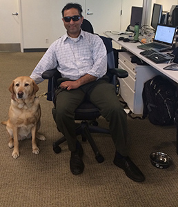 Joel Isaac with guide dog smiling