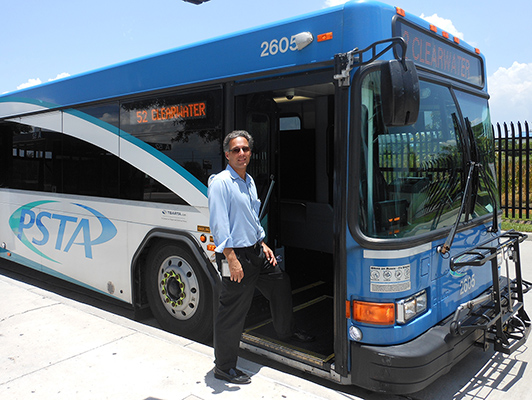 Ross Silvers stepping onto a bus smiling