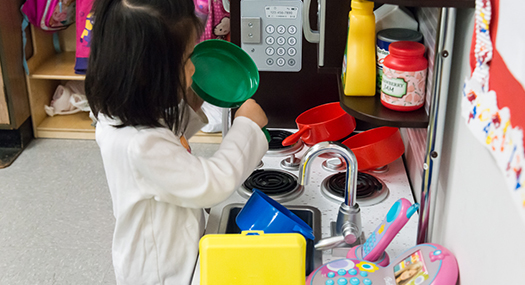 Girl playing in a pretend kitchen