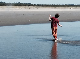 Eddie walking and splashing in ocean