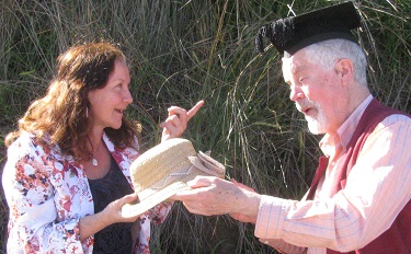 Maribel's father handing hat to Maribel